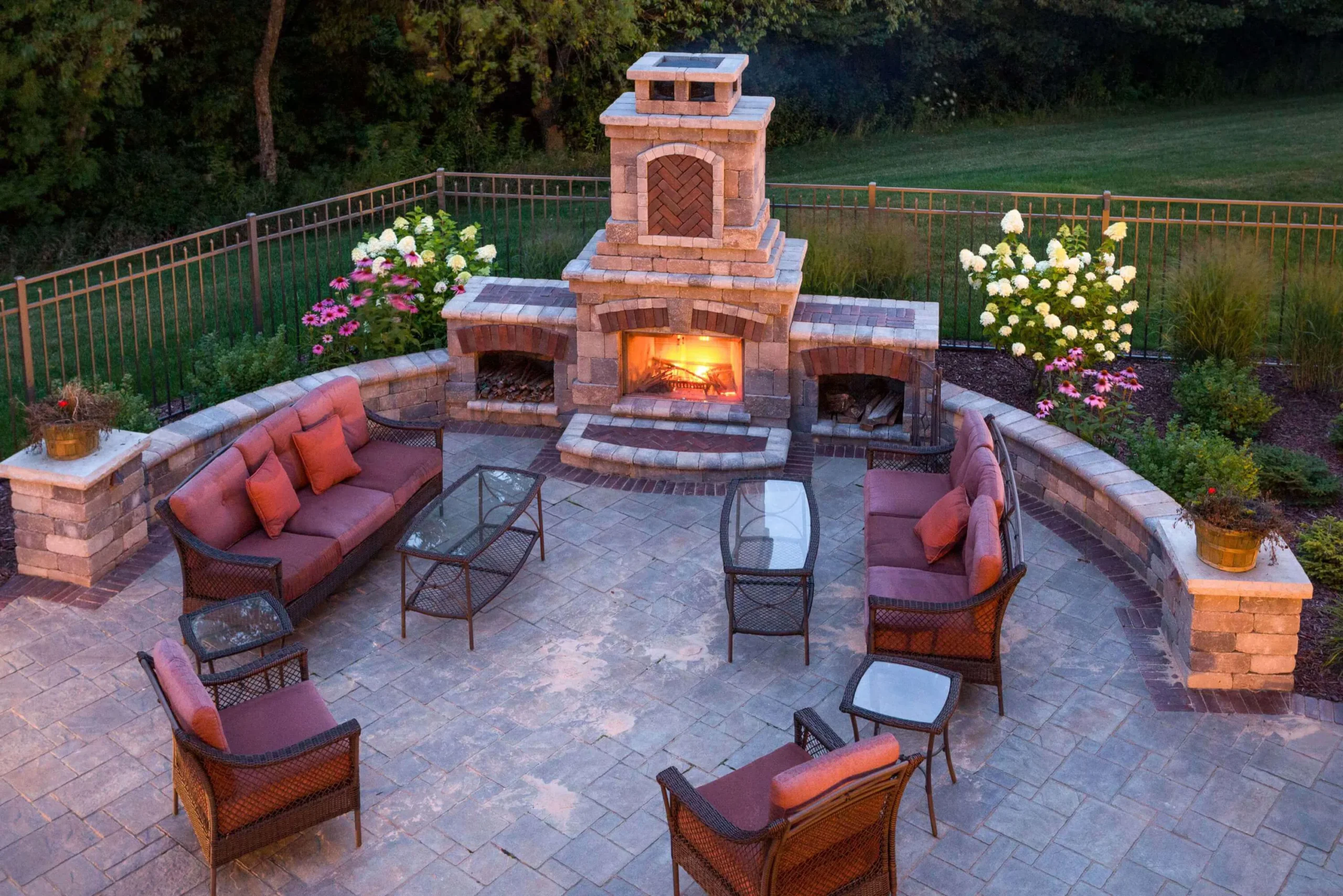 aerial view of a patio furniture set with fireplace blazing